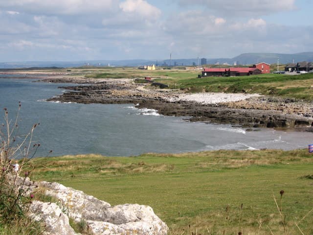 Royal Porthcawl Golf Club viewed from Locks Common, with Rest Bay in the foreground, Wales